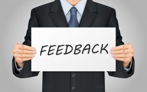 close-up look at businessman holding feedback poster