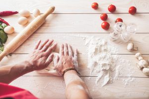 men's hands knead the dough. Ingredients for cooking flour products or dough